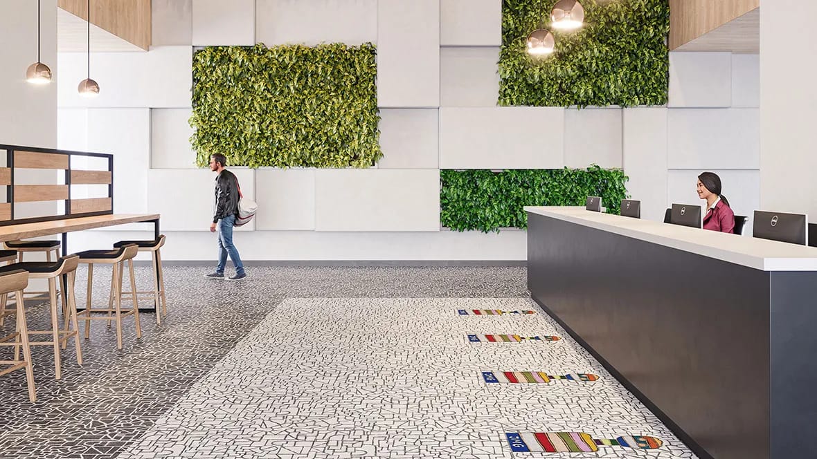 Receptie met plantenwanden en een balie op een wit-zwarte Flotex-vloer met gekleurde motieven